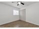 A bright bedroom with wood-style floors, closet, and a ceiling fan at 5316 S Palm Dr, Tempe, AZ 85283