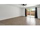 Bright bedroom with wood-look flooring and a sliding glass door at 5316 S Palm Dr, Tempe, AZ 85283