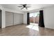 Bright bedroom features a ceiling fan, closet with sliding doors, and wood-look tile flooring at 5316 S Palm Dr, Tempe, AZ 85283
