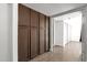 Hallway with wood-look floors and ample storage space with built-in cabinets at 5316 S Palm Dr, Tempe, AZ 85283