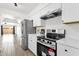 Updated kitchen featuring stainless steel appliances, white cabinetry and a view to the open concept living area at 5316 S Palm Dr, Tempe, AZ 85283