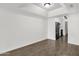 Open-concept space with wood-look flooring and kitchen access at 5316 S Palm Dr, Tempe, AZ 85283