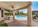 Relaxing outdoor covered porch with ceiling fan and views of a sparkling pool and landscaped yard at 628 N El Dorado Dr, Gilbert, AZ 85233