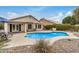 Beautiful in-ground pool surrounded by stone, desert landscaping and mature shrubbery at 628 N El Dorado Dr, Gilbert, AZ 85233
