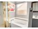 Bright bathroom with a soaking tub, shower, and large window for natural light at 628 N El Dorado Dr, Gilbert, AZ 85233
