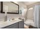 Updated bathroom with a new vanity, mirror, and shower-tub combination at 628 N El Dorado Dr, Gilbert, AZ 85233