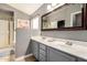 Bathroom features double sinks, gray cabinetry, a large mirror, and a glass-enclosed shower at 628 N El Dorado Dr, Gilbert, AZ 85233