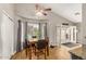 Well-lit dining area features wood floors, a ceiling fan, and direct access to a patio with an outside pool view at 628 N El Dorado Dr, Gilbert, AZ 85233