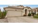 Inviting home with a desert-style front yard, a two-car garage, and a charming entrance, exuding warmth and character at 628 N El Dorado Dr, Gilbert, AZ 85233