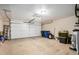 Spacious two car garage with white door, overhead lighting, and ample storage and work space at 628 N El Dorado Dr, Gilbert, AZ 85233