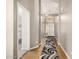 Welcoming hallway features a decorative rug, hardwood floors, and a glimpse into a cozy bedroom, creating an inviting atmosphere at 628 N El Dorado Dr, Gilbert, AZ 85233