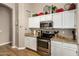 Kitchen showcases stainless steel appliances, granite countertops, and white cabinetry at 628 N El Dorado Dr, Gilbert, AZ 85233