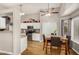 An open kitchen features white cabinetry, stainless appliances, granite countertops, and a dining area at 628 N El Dorado Dr, Gilbert, AZ 85233