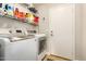 Convenient laundry room featuring a washer, dryer, and shelving at 628 N El Dorado Dr, Gilbert, AZ 85233