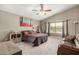 The main bedroom has a ceiling fan, neutral carpeting, large windows, and a warm, inviting ambiance at 628 N El Dorado Dr, Gilbert, AZ 85233