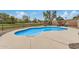 Inviting in-ground swimming pool with cool blue water, desert landscaping, and a view of the community golf course at 628 N El Dorado Dr, Gilbert, AZ 85233