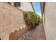 Narrow side yard with paver walkway, rock landscaping, and block wall at 628 N El Dorado Dr, Gilbert, AZ 85233