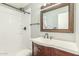A bright bathroom features a shower with tile surround and a classic vanity at 6411 S El Camino Dr, Tempe, AZ 85283