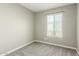 A bright bedroom features neutral colors, carpet and a window at 6411 S El Camino Dr, Tempe, AZ 85283