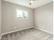 This bedroom features plush carpet, neutral walls, and a ceiling fan at 6411 S El Camino Dr, Tempe, AZ 85283
