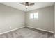 A bright bedroom features neutral colors, carpet and a ceiling fan at 6411 S El Camino Dr, Tempe, AZ 85283