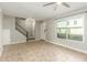 Spacious living room featuring tile flooring, neutral paint, ceiling fan and staircase access at 6411 S El Camino Dr, Tempe, AZ 85283