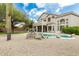 Gorgeous backyard features a sparkling pool, desert landscaping, and stucco exterior at 6916 E Trailridge Cir, Mesa, AZ 85207
