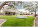 This large backyard offers green lawn, desert landscaping, a swimming pool, and a trampoline at 6916 E Trailridge Cir, Mesa, AZ 85207