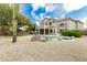 A beautiful backyard features a pool, desert landscaping, and the home's stucco exterior at 6916 E Trailridge Cir, Mesa, AZ 85207