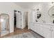 Modern bathroom featuring double sinks, subway tile, herringbone floors and access to a walk-in closet at 6916 E Trailridge Cir, Mesa, AZ 85207
