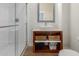 Bright bathroom featuring a glass-enclosed shower and vanity with open storage and stylish baskets at 6916 E Trailridge Cir, Mesa, AZ 85207