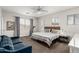 Inviting bedroom featuring a comfortable seating area and views of the neighborhood at 6916 E Trailridge Cir, Mesa, AZ 85207