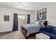 Comfortable bedroom with balcony access, city art and cozy seating area at 6916 E Trailridge Cir, Mesa, AZ 85207