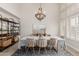 Dining room with modern chandelier, seating for six, and bright natural light at 6916 E Trailridge Cir, Mesa, AZ 85207