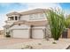 Two-story home with a tile roof, desert landscaping, and a three-car garage at 6916 E Trailridge Cir, Mesa, AZ 85207