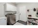 Convenient laundry room with washer, dryer, storage cabinets, and an access door to the outside at 6916 E Trailridge Cir, Mesa, AZ 85207