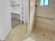 Bathroom featuring tiled shower, grab bar, and adjacent walk-in closet with shelving at 7334 W Comet Ave, Peoria, AZ 85345