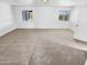 Spacious bedroom with two windows and neutral carpet providing abundant natural light and comfort at 7334 W Comet Ave, Peoria, AZ 85345