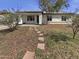 Charming single-story home with a stepping stone walkway and well-manicured lawn at 7334 W Comet Ave, Peoria, AZ 85345