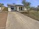 Inviting home exterior featuring a concrete driveway and a well-maintained front yard at 7334 W Comet Ave, Peoria, AZ 85345