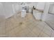 Open kitchen with white cabinetry, stainless steel appliances, and tile flooring at 7334 W Comet Ave, Peoria, AZ 85345