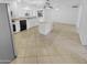 Bright kitchen featuring white cabinets, tiled countertops, and a central island with great space for gatherings at 7334 W Comet Ave, Peoria, AZ 85345