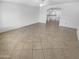 Spacious living room with tile flooring and an open layout leading into the kitchen at 7334 W Comet Ave, Peoria, AZ 85345
