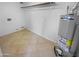 Utility room featuring a water heater, tile flooring, and hookups for laundry appliances at 7334 W Comet Ave, Peoria, AZ 85345