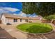 View of the lush green backyard with covered patio at 7839 E Osage Ave, Mesa, AZ 85212