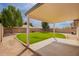 Covered patio and grassy backyard with block wall fence at 7839 E Osage Ave, Mesa, AZ 85212