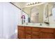 Bathroom featuring a double vanity, large mirror and shower-tub combo at 7839 E Osage Ave, Mesa, AZ 85212