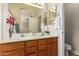Bathroom with double vanity, granite counters, and well-lit mirrors at 7839 E Osage Ave, Mesa, AZ 85212