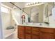Bathroom featuring a double vanity, large mirror and shower-tub combo at 7839 E Osage Ave, Mesa, AZ 85212