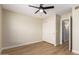 This bedroom features wood floors, ceiling fan, and closet space at 7839 E Osage Ave, Mesa, AZ 85212